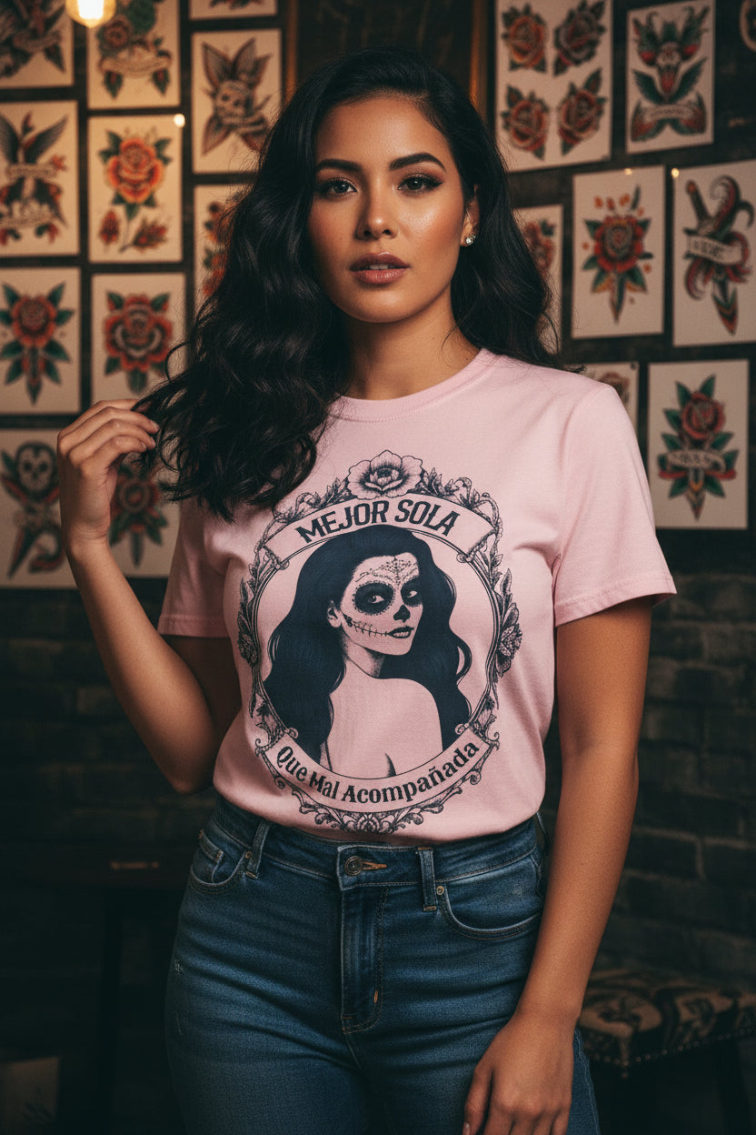 A detailed graphic print of a vintage-style Mexican calavera silhouette featuring the text “Mejor Sola Que Mal Acompañada” on a heavyweight Comfort Colors shirt.