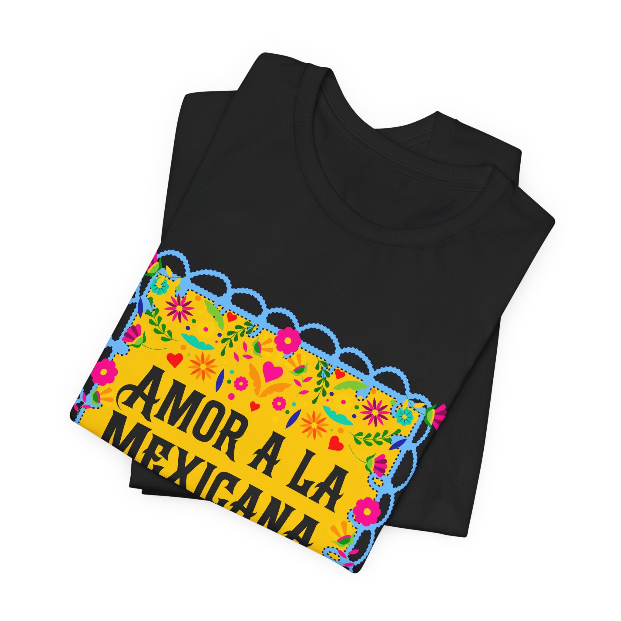 T-shirt with pink "Amor a la Mexicana" text surrounded by a colorful floral frame inspired by Mexican folk art.