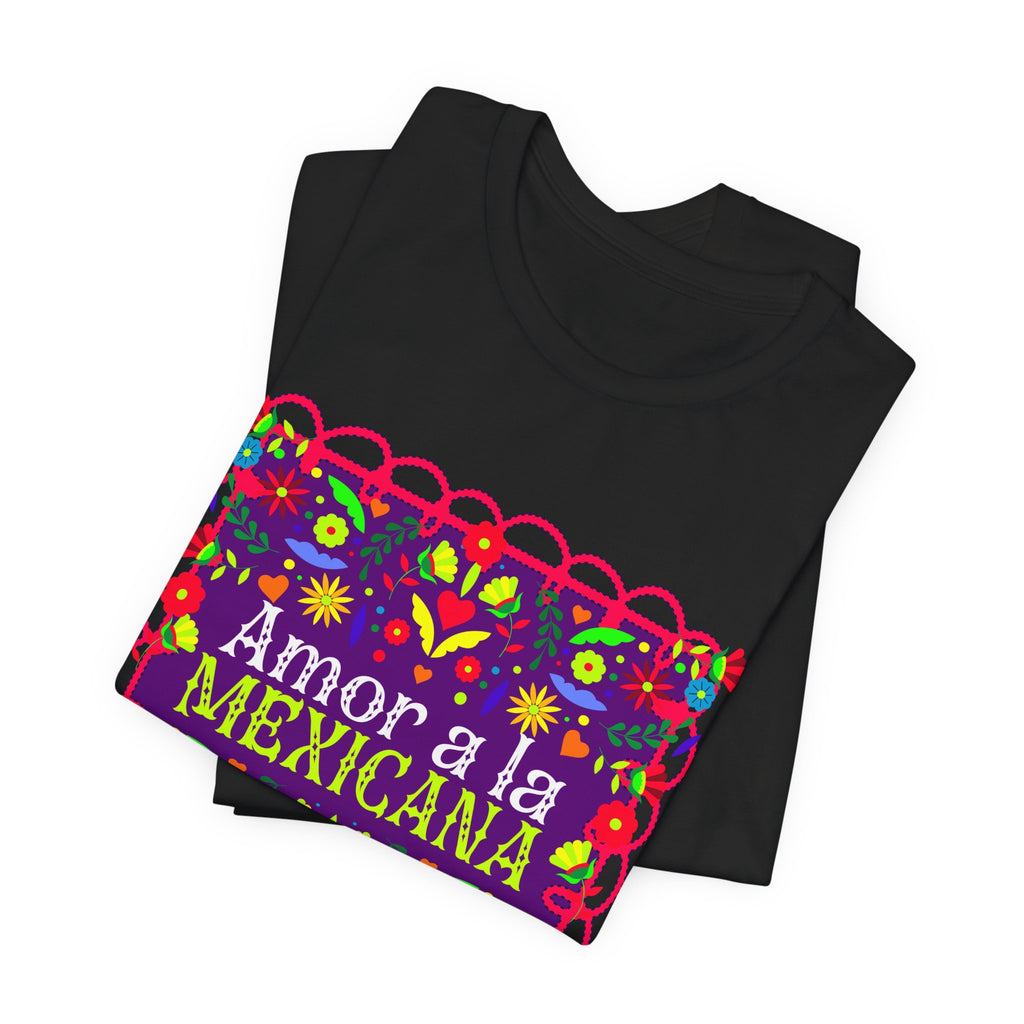 t-shirt with pink "Amor a la Mexicana" text surrounded by a colorful floral frame inspired by Mexican folk art.