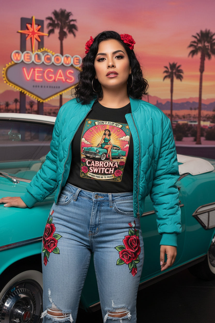 vintage-style t-shirt featuring a pin-up woman sitting on a turquoise lowrider car with roses and the text Cabrona Switch.