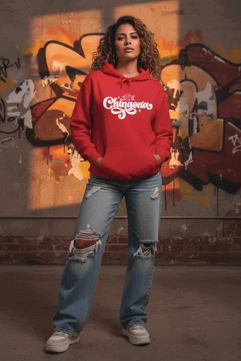 Latina woman wearing red Chingona hoodie - bold white script rose design closeup