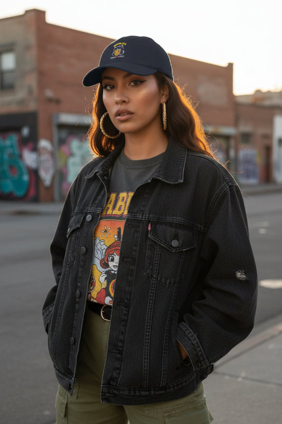 Beautiful Latina woman wearing navy blue Diablita Pero Cute embroidered dad cap in retro Chicana streetwear style