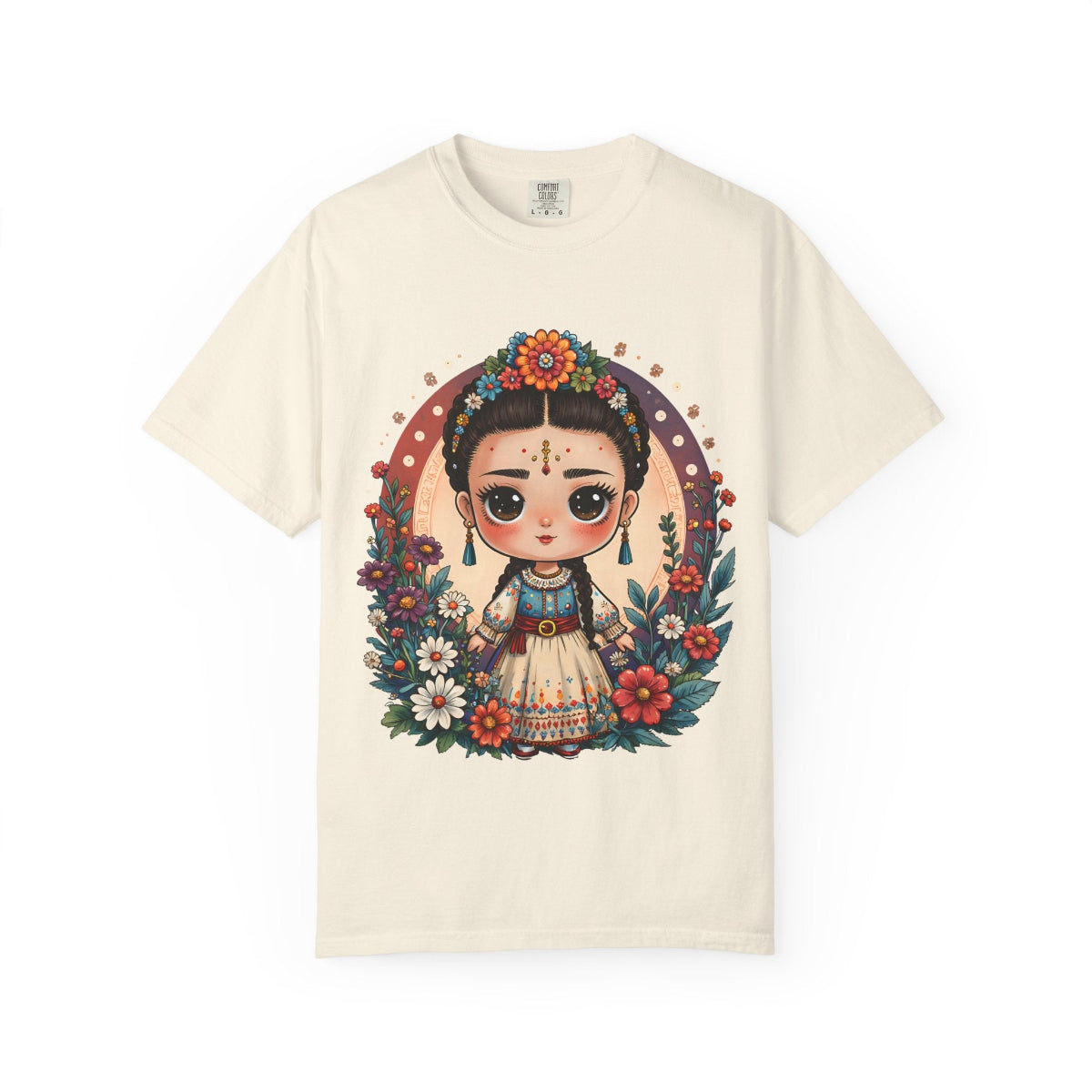 Whimsical Mexican folk art doll with floral crown and celestial accents on a heavyweight cotton t-shirt.