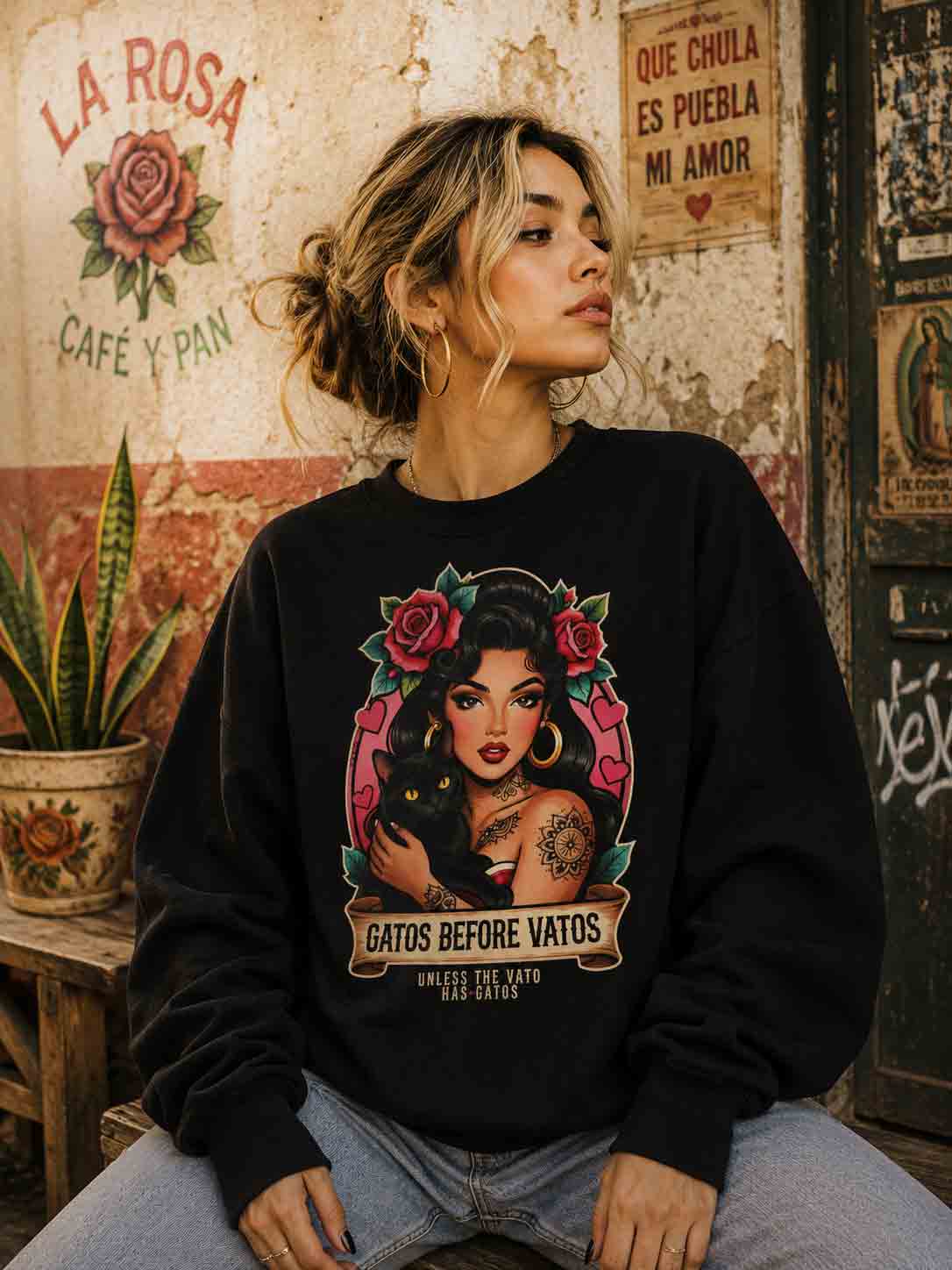 Chicana woman with cat wearing Gatos Before Vatos sweatshirt, urban fashion, Latina pride.