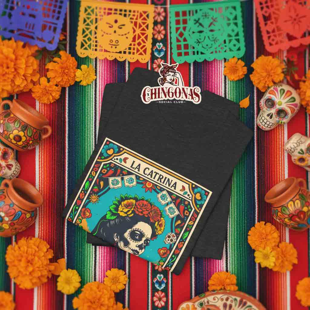T-shirt with a vintage Lotería style card design featuring La Catrina No. 54, surrounded by flowers, cactus, and a guitar.