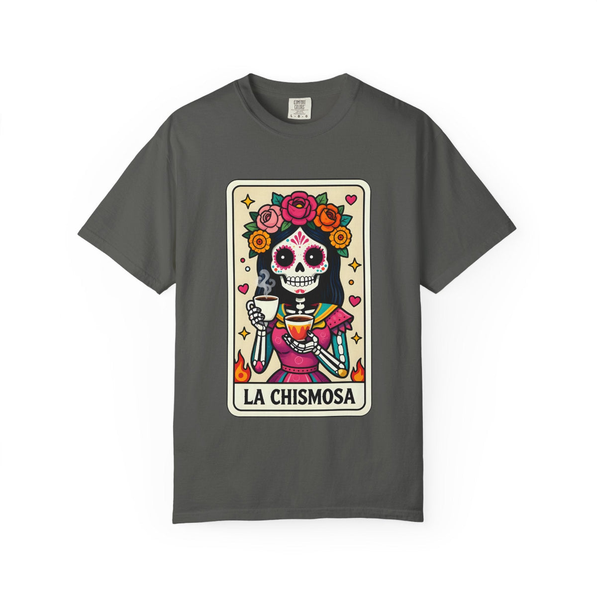 Vintage lotería card design on a t-shirt featuring a sugar skull calavera holding a coffee cup with the text La Chismosa.