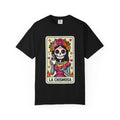 Vintage lotería card design on a t-shirt featuring a sugar skull calavera holding a coffee cup with the text La Chismosa.