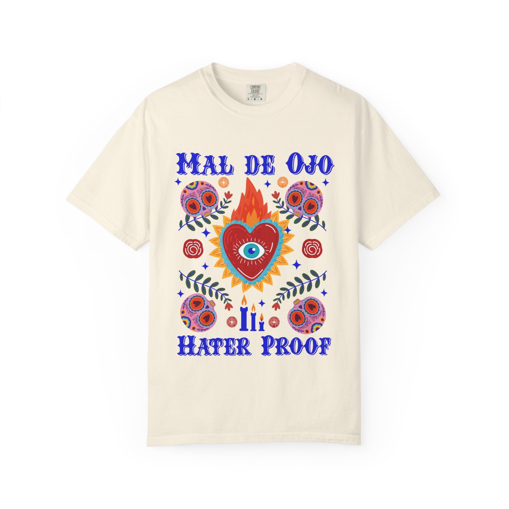 Heavyweight T-shirt featuring a colorful Sacred Heart graphic, a protective eye, and the phrase “Mal de Ojo Hater Proof.”