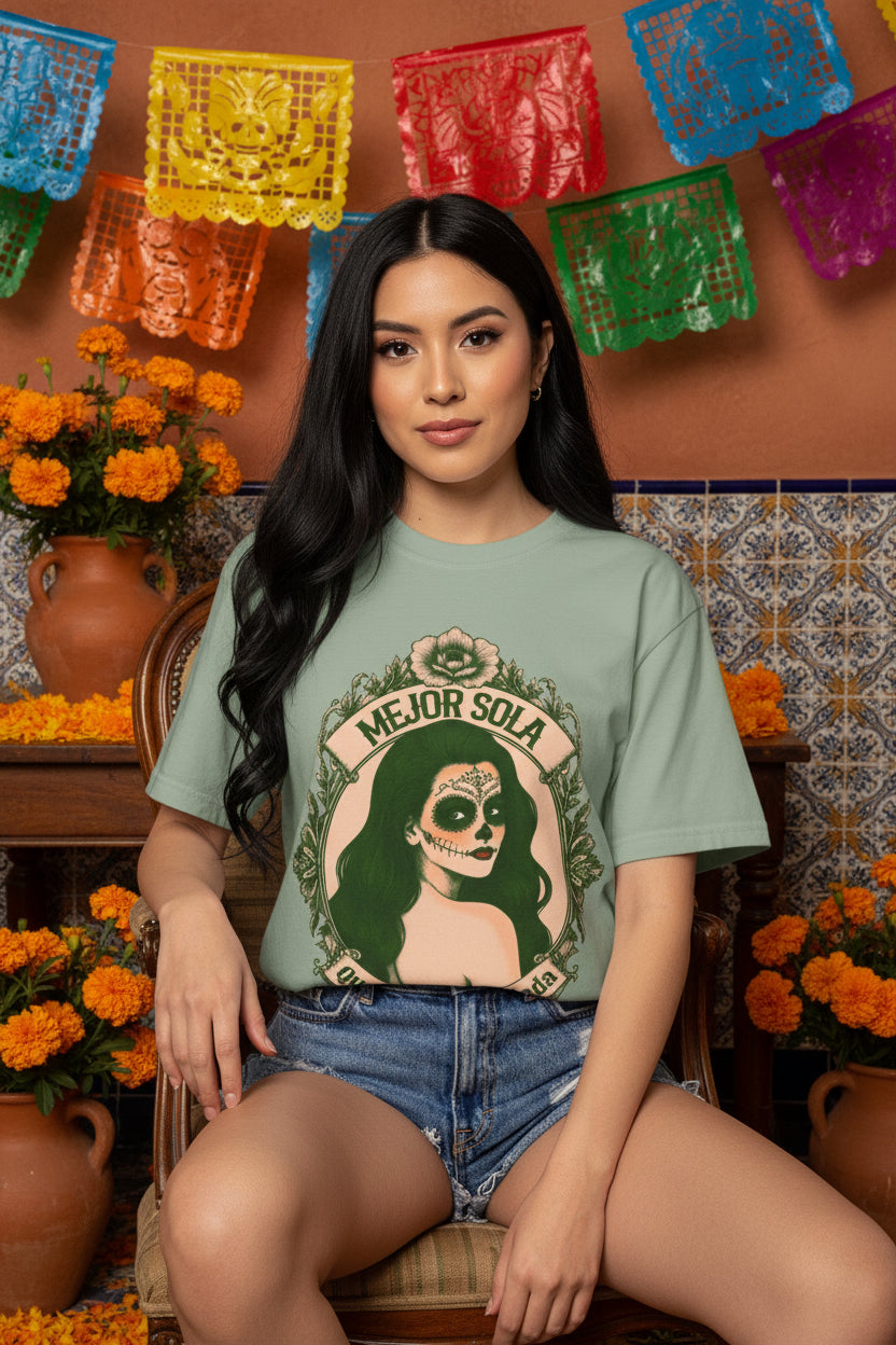 Vintage-inspired design featuring a framed portrait of La Calavera Catrina and the phrase “Better alone than in bad company” on a loose-fitting T-shirt from Comfort Colors.
