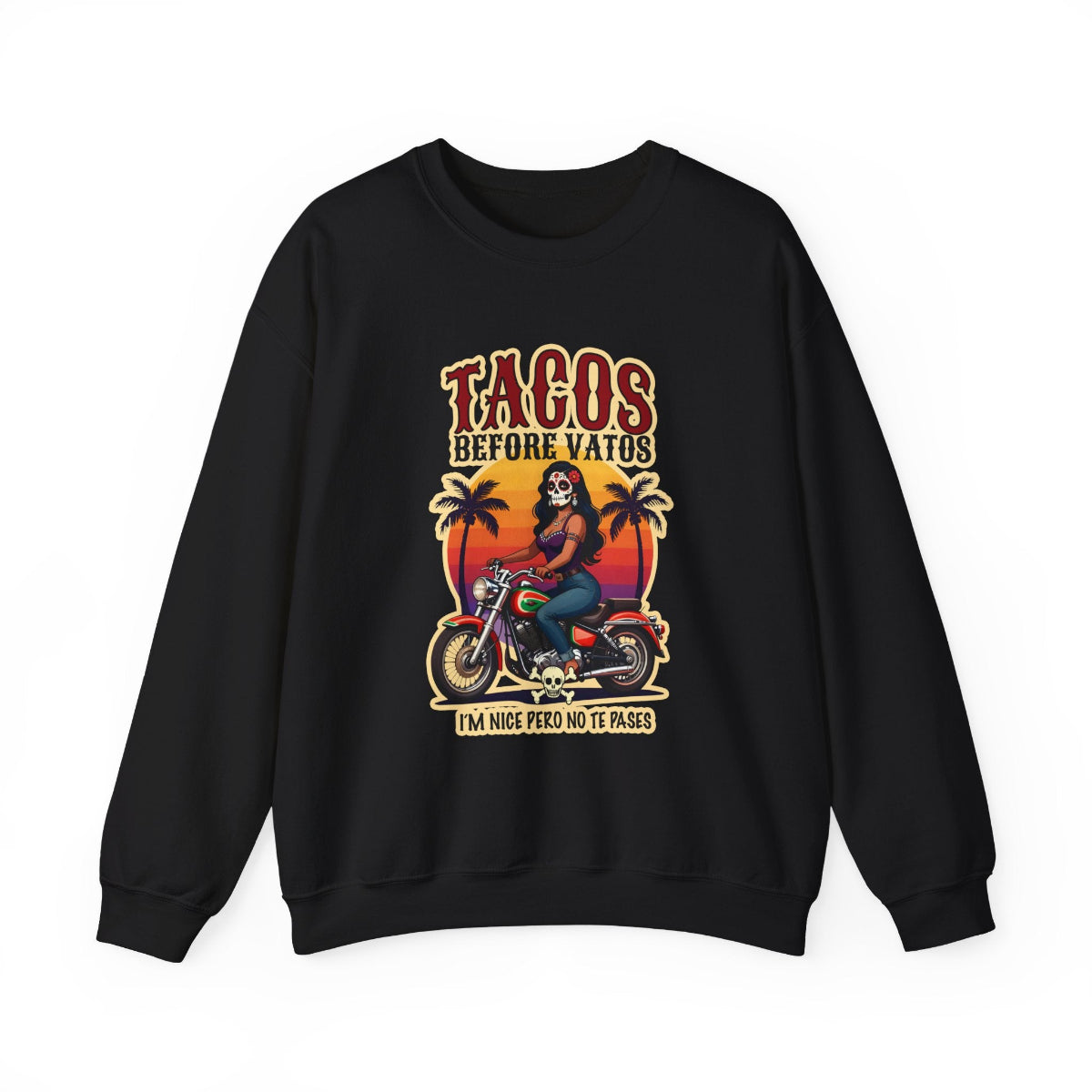 The bold “Tacos Before Vatos” lettering, featuring a vintage design of a Chicana riding a motorcycle at sunset, on a comfortable crew-neck sweatshirt.