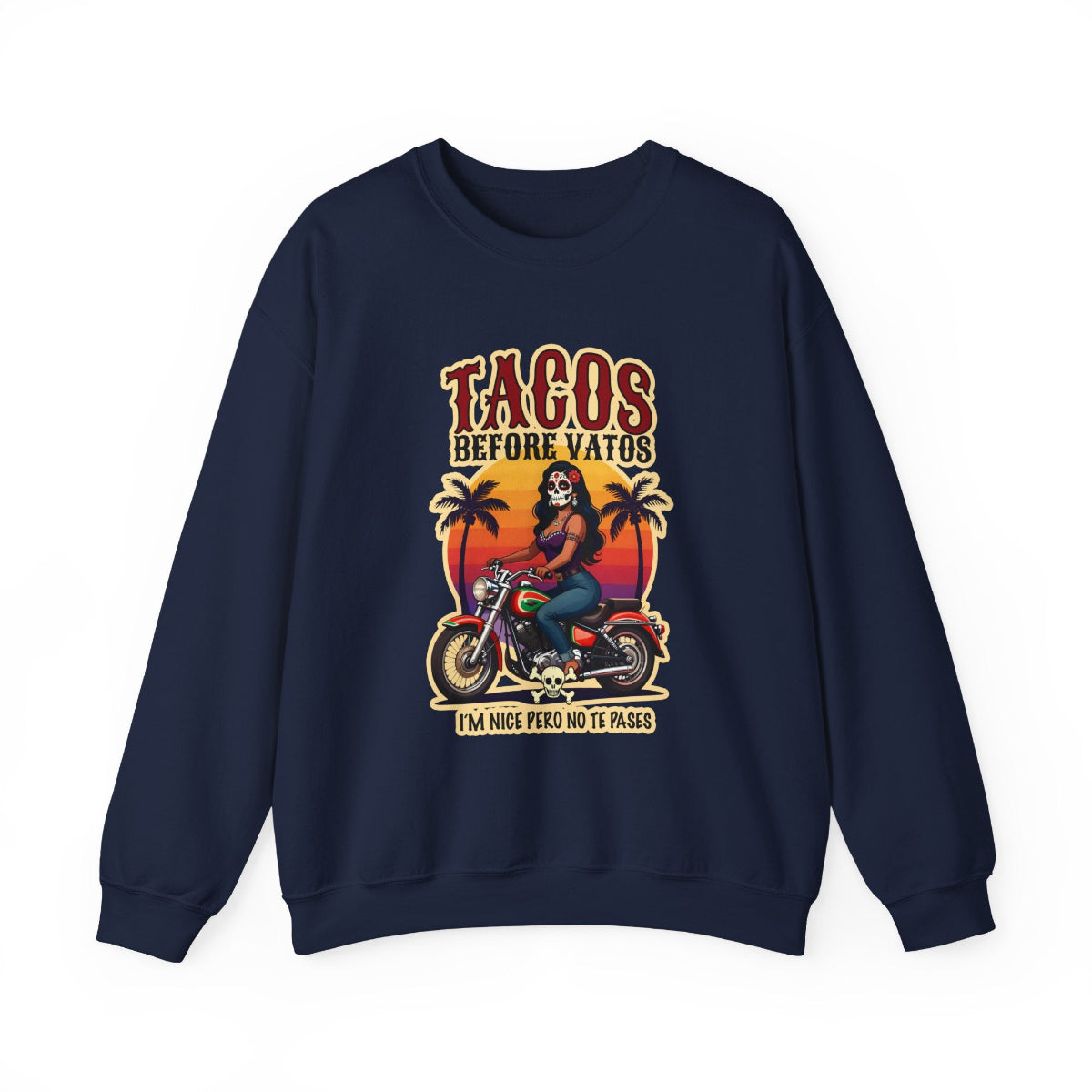 The bold “Tacos Before Vatos” lettering, featuring a vintage design of a Chicana riding a motorcycle at sunset, on a comfortable crew-neck sweatshirt.