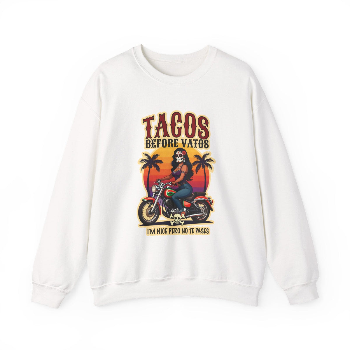 The bold “Tacos Before Vatos” lettering, featuring a vintage design of a Chicana riding a motorcycle at sunset, on a comfortable crew-neck sweatshirt.