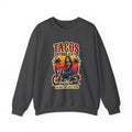 The bold “Tacos Before Vatos” lettering, featuring a vintage design of a Chicana riding a motorcycle at sunset, on a comfortable crew-neck sweatshirt.