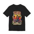 Retro biker t-shirt with a woman riding a motorcycle, sunset background, and the text Tacos Before Vatos I'm Nice Pero No Te Pases.