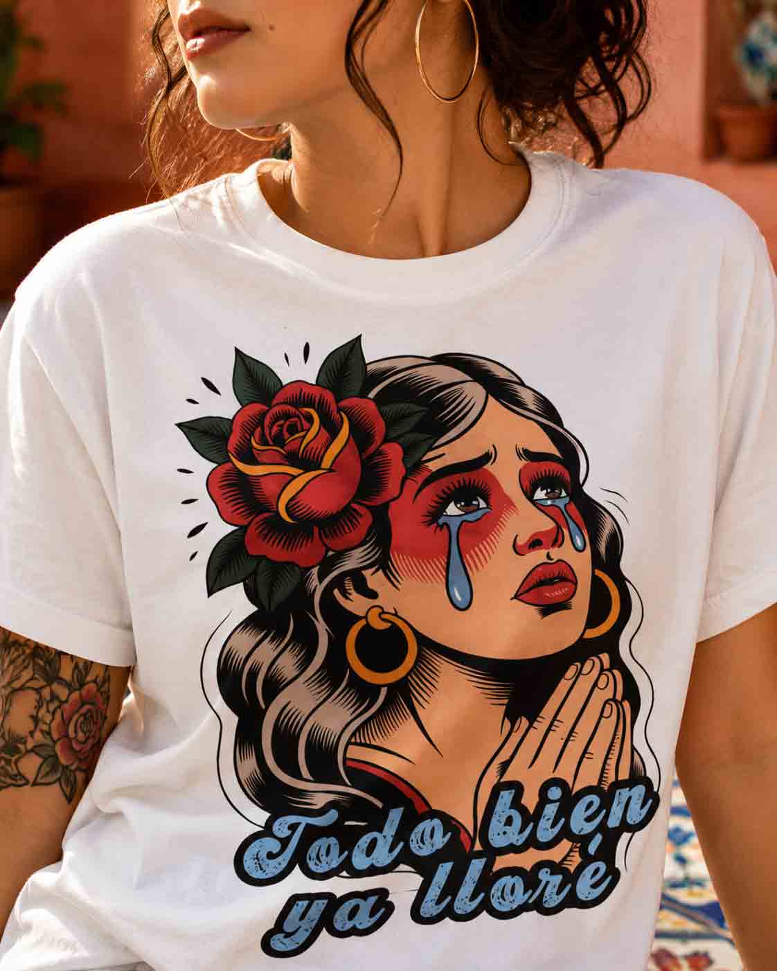 White t-shirt featuring a vintage illustration of a crying woman with a rose and the Spanish phrase Todo Bien Ya Lloré.